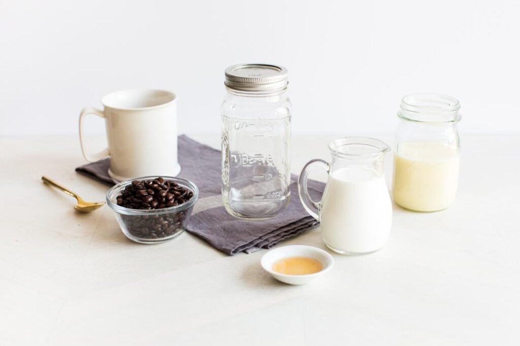 Ingredients for homemade coffee creamer including milk, heavy cream, vanilla, and sweetener